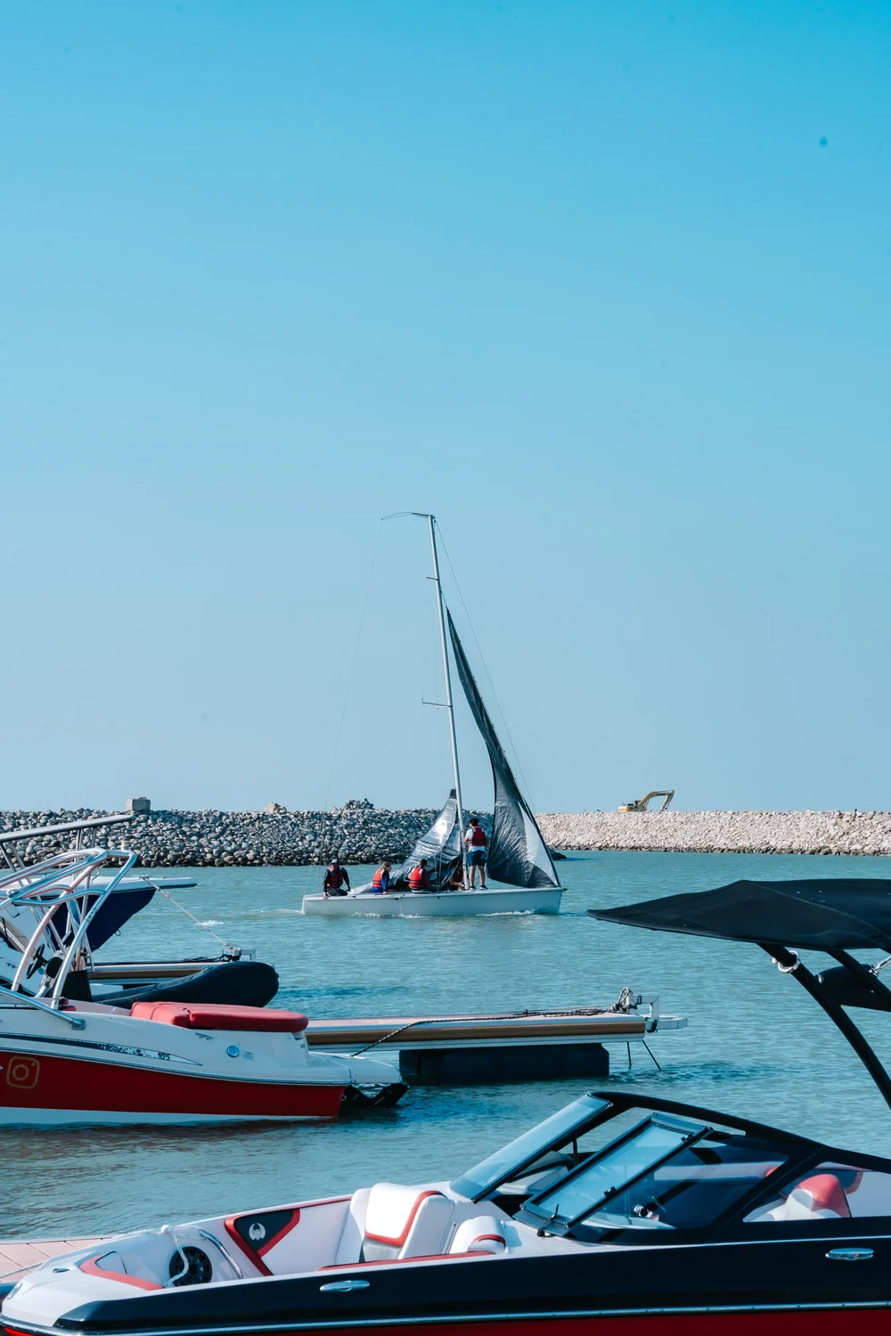 A sailboat leaves the harbor